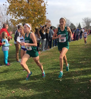 Gabby Skopec 17 (left) and Bailey Nock 18 (right) run together  at the Iowa State Meet on October 29.