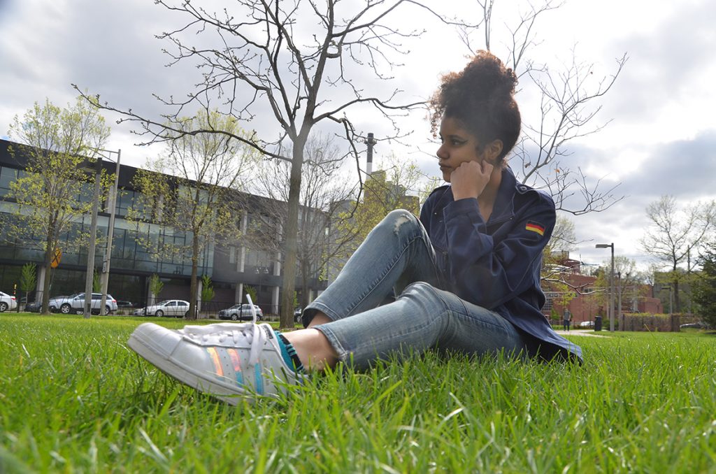 Emina Abdagic 17 lays in the grass in downtown Iowa City to enjoy the warm weather.