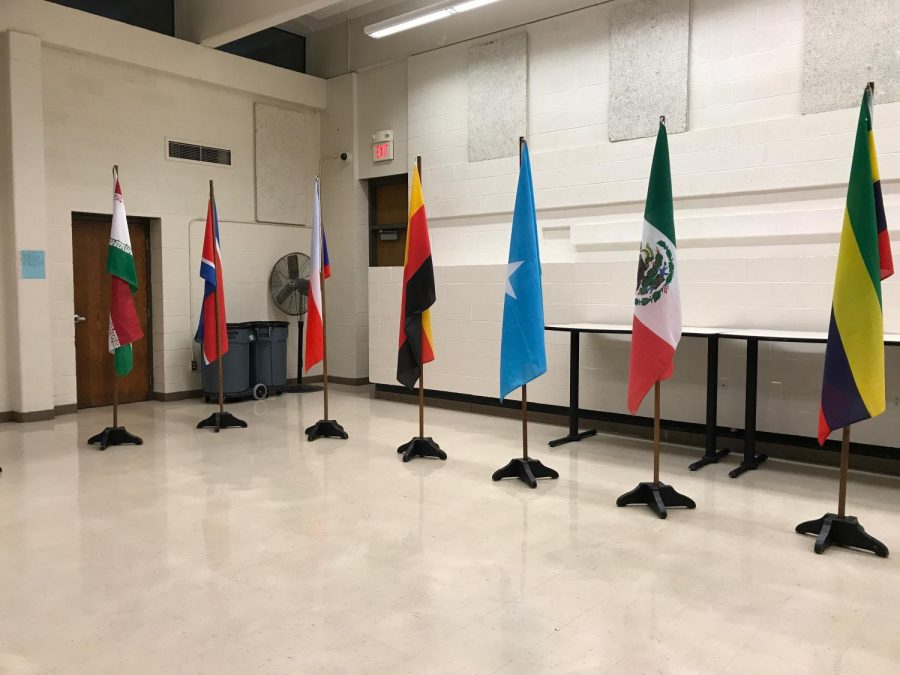 Flags are spread out around the cafeteria, representing diversity.