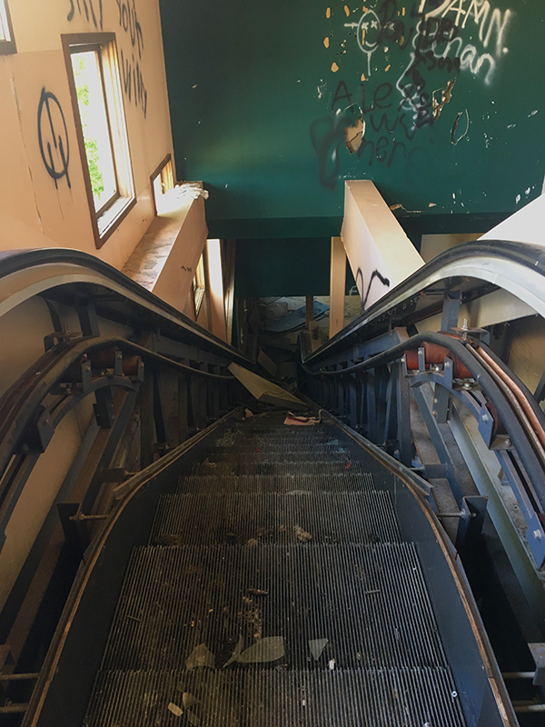 The escalator in the abandoned Greyhound Park in Waterloo, Iowa  remains partially intact as rust and time takes over. The park used for dog races, now sits off the highway collecting dust and graffiti. 