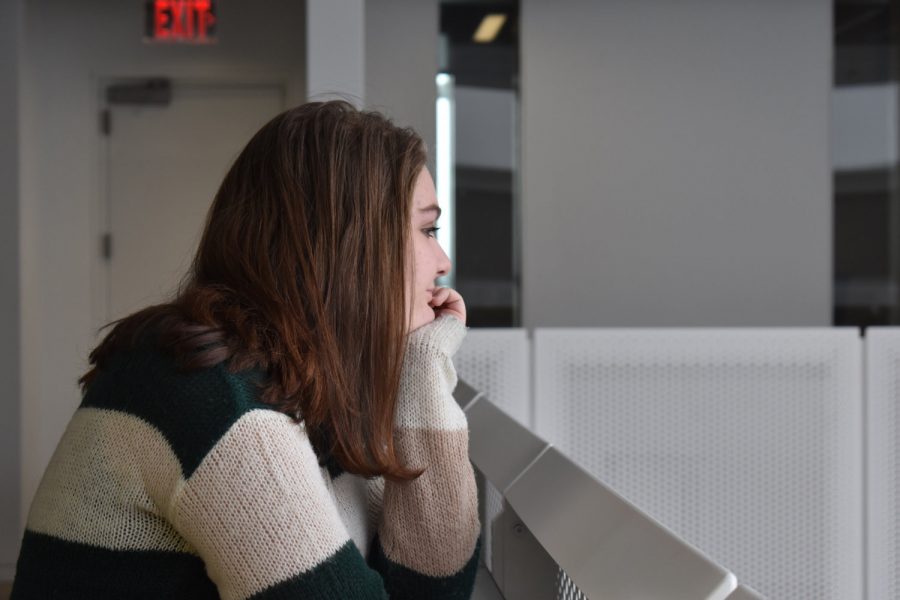 Grace Christopher ‘19 stares wishfully out the window as she hopes for another snow day. Aren’t we all? --Feature Image
