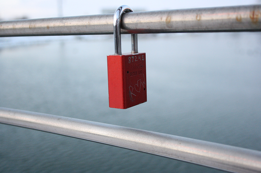 One of many locks on the Iowa River Trail that signifies the love between two people. Couples commonly place a lock on the railing and throw the key in the river to show their undying love. 
(Featured)