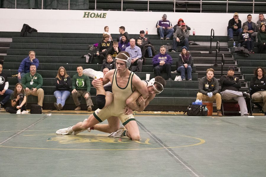 Graham Gambrall 21 takes down his opponent from Linn-Mar.